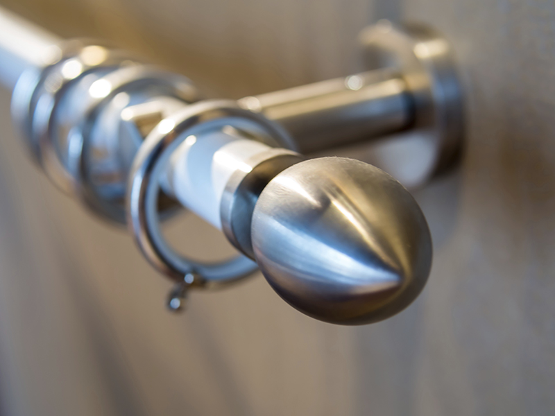 Stainless curtain rod on the wooden wall